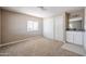 A carpeted bedroom features a closet, a sink/vanity, and a light-filled window at 8600 E Broadway Rd # 53, Mesa, AZ 85208