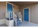 Exterior shot of a front porch with stairs leading up to two blue doors at 8600 E Broadway Rd # 53, Mesa, AZ 85208