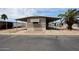 A well-maintained home with a covered carport and palm trees at 8600 E Broadway Rd # 53, Mesa, AZ 85208
