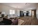 Bright living room featuring modern furniture, wood-look floors, and a seamless flow into the kitchen at 8600 E Broadway Rd # 53, Mesa, AZ 85208
