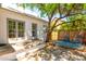 Charming backyard patio area with mature tree, seating, and stylish outdoor rug at 917 W Willetta St, Phoenix, AZ 85007