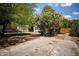 A lush backyard featuring mature trees, a well-maintained lawn, and a wooden fence for added privacy and seclusion at 917 W Willetta St, Phoenix, AZ 85007