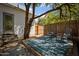 Outdoor back patio featuring a bamboo fence, two chairs, and a large tree at 917 W Willetta St, Phoenix, AZ 85007