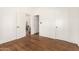 Cozy bedroom with hardwood floors, white walls, and doorway to an adjacent space at 917 W Willetta St, Phoenix, AZ 85007