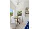 Cozy breakfast nook filled with light, featuring a round table, white chairs, and quaint built-in shelving at 917 W Willetta St, Phoenix, AZ 85007