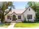 Charming single-story home featuring a white stucco exterior, green door, and lush landscaping at 917 W Willetta St, Phoenix, AZ 85007