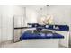 Stylish kitchen with stainless steel appliances, blue-tiled countertops, and ample cabinet space at 917 W Willetta St, Phoenix, AZ 85007