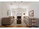 Bright living room featuring neutral sofas, a fireplace, and hardwood floors at 917 W Willetta St, Phoenix, AZ 85007