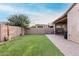 Backyard featuring artificial turf, patio, barbecue grill, and overhead string lighting at 9831 E Tupelo Ave, Mesa, AZ 85212