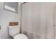 Neutral bathroom with a toilet, a shower with a curtain and a window at 9831 E Tupelo Ave, Mesa, AZ 85212