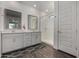 Modern bathroom with a double vanity, framed mirrors, glass shower, and contemporary finishes at 9831 E Tupelo Ave, Mesa, AZ 85212
