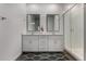 Well-lit bathroom featuring a double vanity, framed mirrors, glass shower, and contemporary finishes at 9831 E Tupelo Ave, Mesa, AZ 85212