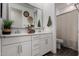 Bright bathroom featuring double sinks, white cabinets, and decorative wall accents at 9831 E Tupelo Ave, Mesa, AZ 85212