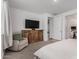Bedroom featuring a comfy chair and a TV atop a wooden dresser at 9831 E Tupelo Ave, Mesa, AZ 85212