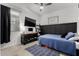 Bedroom with a bed, a window, a TV, and decorative shelving at 9831 E Tupelo Ave, Mesa, AZ 85212