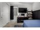 Bedroom with a bed, a window, a TV, and decorative shelving at 9831 E Tupelo Ave, Mesa, AZ 85212