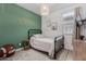 Charming bedroom features a green accent wall with modern decor and a cozy black metal bed frame at 9831 E Tupelo Ave, Mesa, AZ 85212