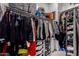 A walk-in closet with ample storage solutions, including shelves, hanging rods, and organized clothing at 9831 E Tupelo Ave, Mesa, AZ 85212