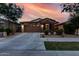 Charming single-Gathering home boasting a two-car garage and stone veneer, complemented by a well-manicured lawn at 9831 E Tupelo Ave, Mesa, AZ 85212