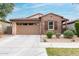 Charming single-story home boasts brick accents, a two-car garage, and desert landscaping for easy maintenance at 9831 E Tupelo Ave, Mesa, AZ 85212
