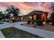 Exterior view of a single-Gathering home with a driveway, landscaping, and evening sky at 9831 E Tupelo Ave, Mesa, AZ 85212
