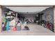 Spacious two-car garage with storage, sports equipment, and room for vehicles at 9831 E Tupelo Ave, Mesa, AZ 85212