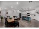 Open kitchen with island seating, dark dining set, recessed lighting, and wood-look floors at 9831 E Tupelo Ave, Mesa, AZ 85212