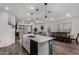 Open kitchen with island, recessed lighting, and stainless appliances, adjacent to a dining area and living space at 9831 E Tupelo Ave, Mesa, AZ 85212