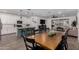 Open-concept kitchen with island seating, pendant lighting, and a dining table for meal prep and dining at 9831 E Tupelo Ave, Mesa, AZ 85212