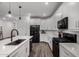 Open kitchen features white cabinets, stone countertops, stainless steel appliances and plank flooring at 9831 E Tupelo Ave, Mesa, AZ 85212