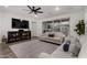 Comfortable living room featuring two sofas, dark ceiling fan and decorative shelves at 9831 E Tupelo Ave, Mesa, AZ 85212