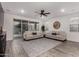 Spacious living room with wood-look floors, neutral paint, and a sliding glass door for ample natural light at 9831 E Tupelo Ave, Mesa, AZ 85212