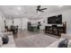 Open-concept living space featuring sleek floors and a modern kitchen with island seating and ample storage at 9831 E Tupelo Ave, Mesa, AZ 85212
