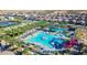 Aerial view of large pool area with winding pool, water feature, and slides at 9831 E Tupelo Ave, Mesa, AZ 85212
