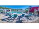 Relaxing pool area with lounge chairs and colorful slides in the background at 9831 E Tupelo Ave, Mesa, AZ 85212