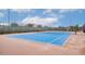 Bright blue tennis court offers an appealing amenity for an active lifestyle in this community at 9831 E Tupelo Ave, Mesa, AZ 85212