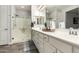 Bright bathroom featuring a double sink vanity and walk-in showers behind glass doors at 10310 E Tillman Ave, Mesa, AZ 85212