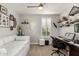 Multi-purpose spare bedroom featuring a daybed, desk, and shelving for display at 10310 E Tillman Ave, Mesa, AZ 85212