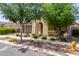 Attractive single-story home with arched entryway and desert landscaping including mature shade trees and a fire hydrant at 10310 E Tillman Ave, Mesa, AZ 85212