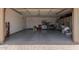 Spacious two-car garage with epoxy flooring and ample storage cabinets at 10310 E Tillman Ave, Mesa, AZ 85212