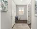 Hallway featuring a built-in bench, neutral colors, and ample natural light from window at 10310 E Tillman Ave, Mesa, AZ 85212