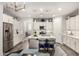 Bright kitchen features stainless steel appliances, island with seating, pendant lights, open access to the living room at 10310 E Tillman Ave, Mesa, AZ 85212