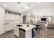 Bright kitchen featuring stainless steel appliances, white cabinets, kitchen island, and an eat-in kitchen at 10310 E Tillman Ave, Mesa, AZ 85212