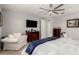 Well-lit main bedroom with comfortable seating, a TV, and neutral color palette at 10310 E Tillman Ave, Mesa, AZ 85212