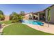 Beautiful pool area featuring mature landscaping and a covered patio at 10310 E Tillman Ave, Mesa, AZ 85212