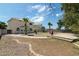 Large backyard with a patio, trees, palm trees, desert landscaping, and a decorative fire pit at 1106 E Altadonna St, San Tan Valley, AZ 85140