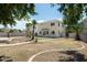Spacious backyard featuring block fencing, mature trees, palm trees, and brick-lined garden, perfect for outdoor enjoyment at 1106 E Altadonna St, San Tan Valley, AZ 85140