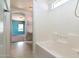 Bright bathroom includes a shower and tub combo, vanity and arched doorway at 1106 E Altadonna St, San Tan Valley, AZ 85140