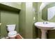 This half bathroom offers a pedestal sink and neutral paint at 1106 E Altadonna St, San Tan Valley, AZ 85140
