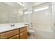 Well-lit bathroom featuring a vanity with a wooden cabinet, toilet, tub, and shower at 1106 E Altadonna St, San Tan Valley, AZ 85140